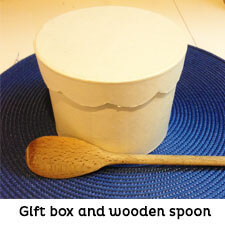 White round gift box and wood spoon