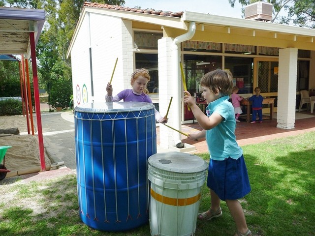 kids playing drums outside