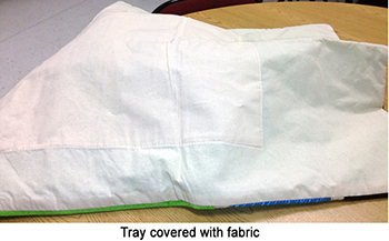 Large tray covered with white fabric