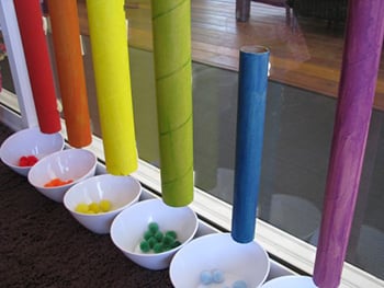Cardboard tubes and pom pons for color drop and plop activity