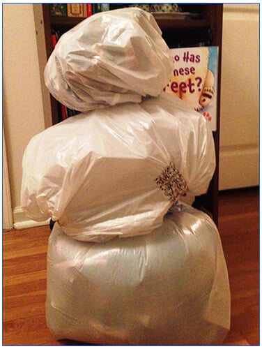 White trash bags filled with paper making a snowman