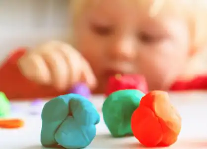 Child exploring dough in open-ended art activity