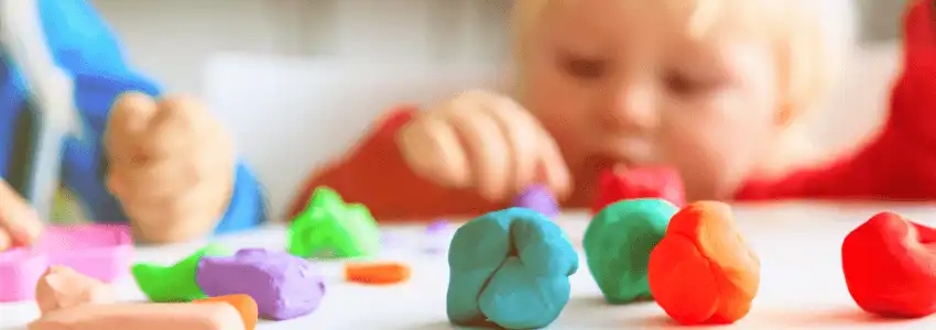 Child exploring dough in open-ended art activity