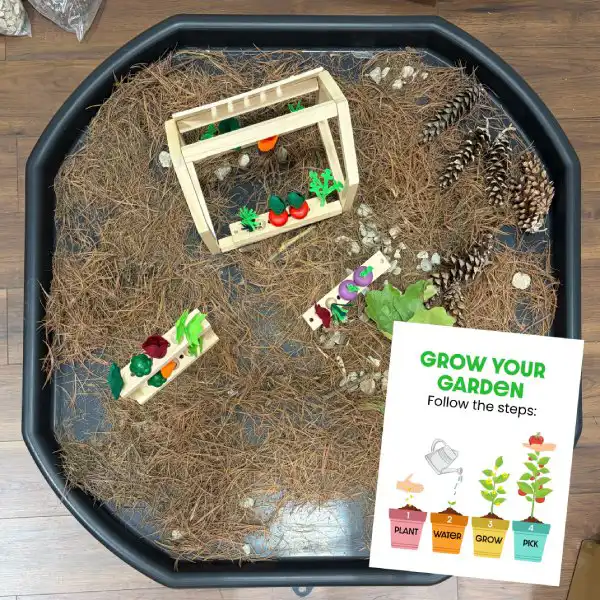 Garden-themed tuff tray activity for preschool science and sensory learning.