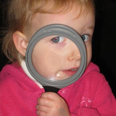 infant with magnifying glass