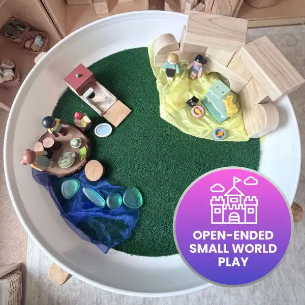 Small-world tuff tray activity exploring homes, families, and communities.