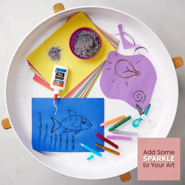 Sparkly sensory tuff tray activity that supports creativity and fine motor skills.