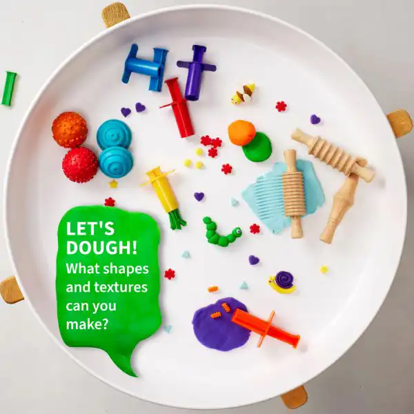Hands-on tuff tray activity with dough for sensory exploration and fine motor development.