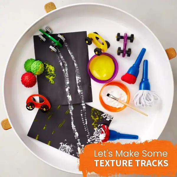 Paint and texture tuff tray activity for sensory exploration and creativity.