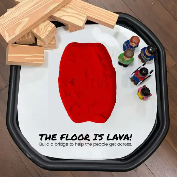 Imaginative tuff tray activity encouraging movement and problem-solving skills.