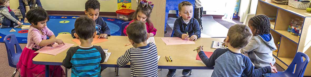 Preschool children sitting at a Jonti-Craft maple top activity table