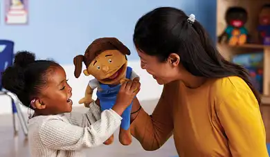 Teacher and child with an MVP Kids puppet