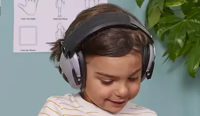Preschool child wearing noise-cancelling headphones