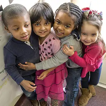 ​Diverse preschool children hugging