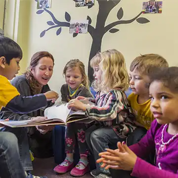 Preschool teacher reading to children