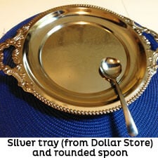 Silver serving tray and silver spoon