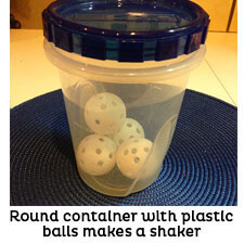 Tall round plastic container with lid filled with plastic balls