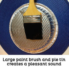 Metal pie tin and large paint brush