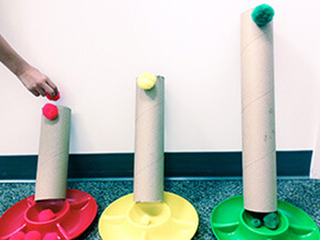 Cardboard tubes and pom pons for color drop and plop activity