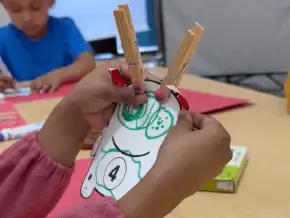 ​​Child holding math monster clothespin learning activity​