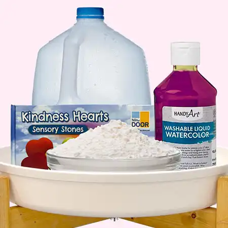 ​​Water, cornstarch, liquid watercolor, Kindness Hearts, and Tuff Tray for Becker&rsquo;s ECE sensory activity.​