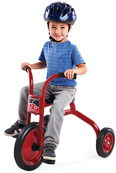 Preschool Boy wearing helmet riding ClassicRider Trike