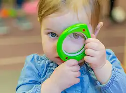 Toddler looking through leaf magnifier