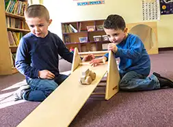 Preschool children playing with STEM ramp