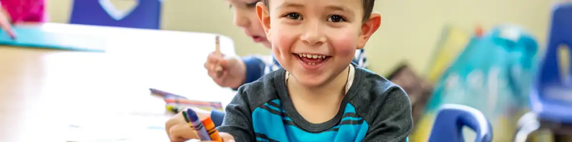 Preschool boy holding crayon