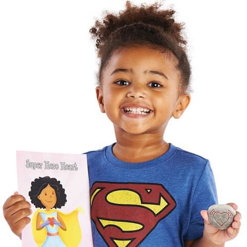Preschool child holding mindfulness card and mindfulness pebble