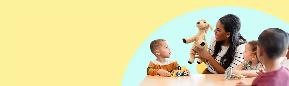 Preschool teacher using puppet to engage children