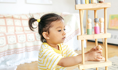 Preschool child playing with people figures
