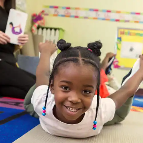 Preschool child doing a yoga pose