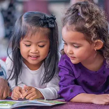 Toddlers reading a book