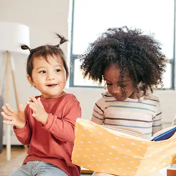 Toddlers reading a book